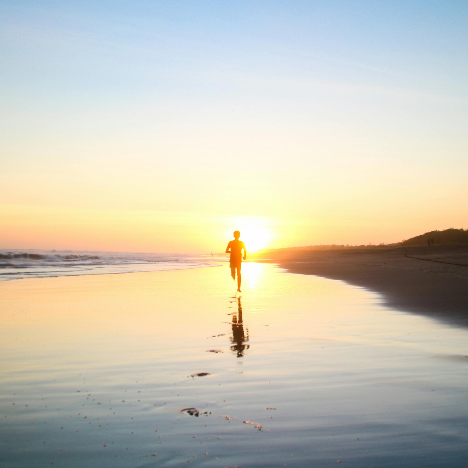 Silhouette of Boy Running in Body of Water during Sunset.