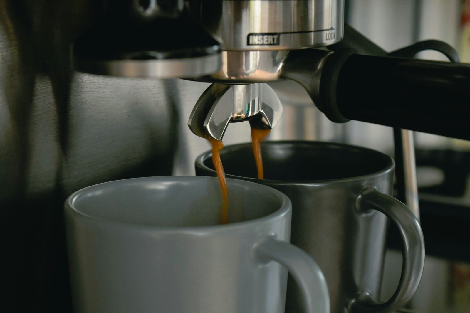 coffee pouring in two mugs