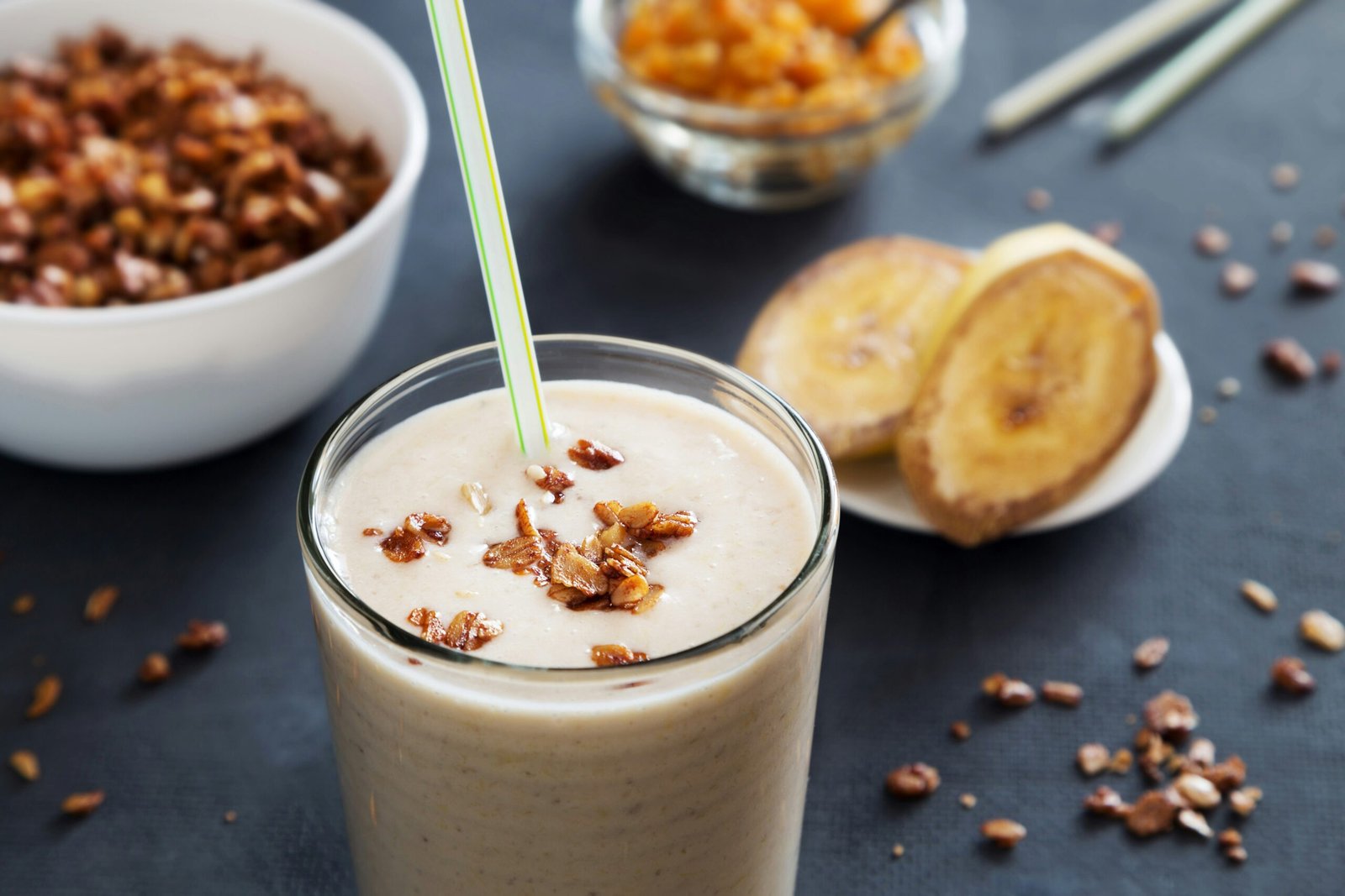 Banana milkshake with straw and granola.