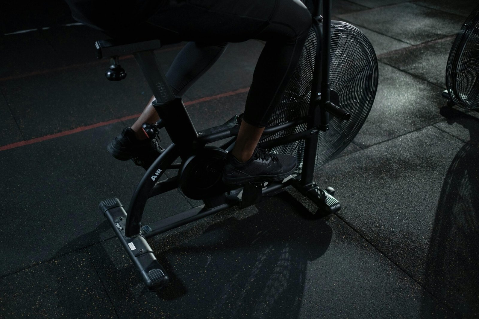 Focused indoor workout on exercise bike showcasing active lifestyle and fitness training.
